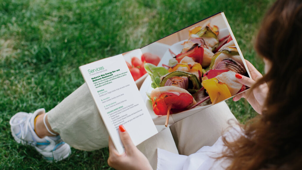 Substance brochure design for Natures Way wellness, a woman is looking at an open spread that shows a healthy recipe
